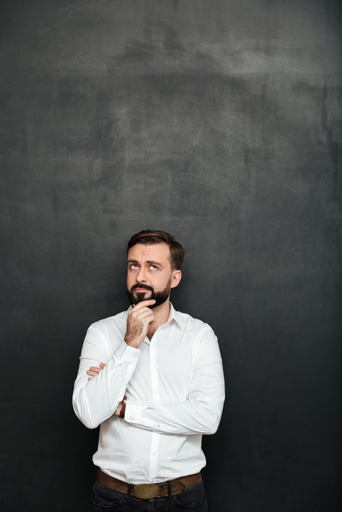 portrait-brunette-bearded-man-white-shirt-touching-his-chin-thinking-remembering-dark-gray portrait-brunette-bearded-man-white-shirt-touching-his-chin-thinking-remembering-dark-gray